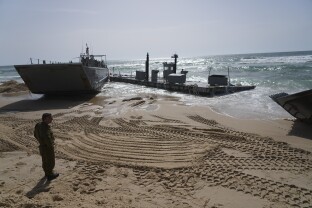A U.S. Army landing craft is beached after being swept by wind and current from the temporary humanitarian pier in the Gaza Strip.