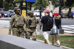 National Guard members are seen alongside tourists on the National Mall in Washington, D.C.