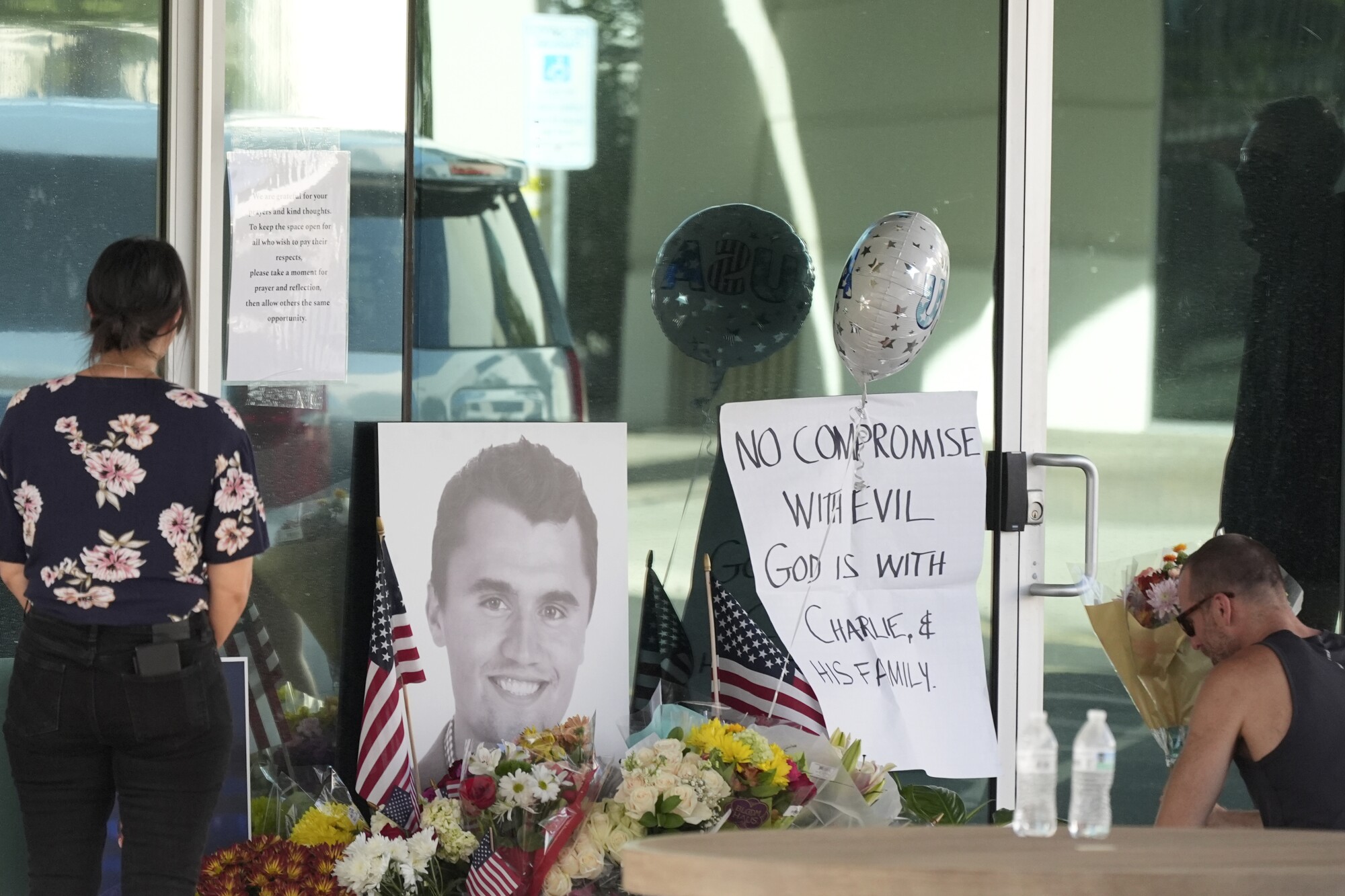 Well-wishers pay their respects to the late Charlie Kirk at a makeshift memorial at the national headquarters of Turning Point USA
