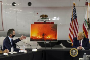 Donald Trump listens as California Gov. Gavin Newsom speak during a wildfire briefing in 2020.
