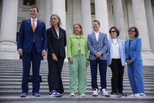 Members of the Congressional Sneaker Caucus pose for a photo outside the U.S. Capitol.