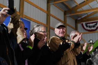 Minn. Gov. Tim Walz listens to President Biden speak during the Rural America Event Series.