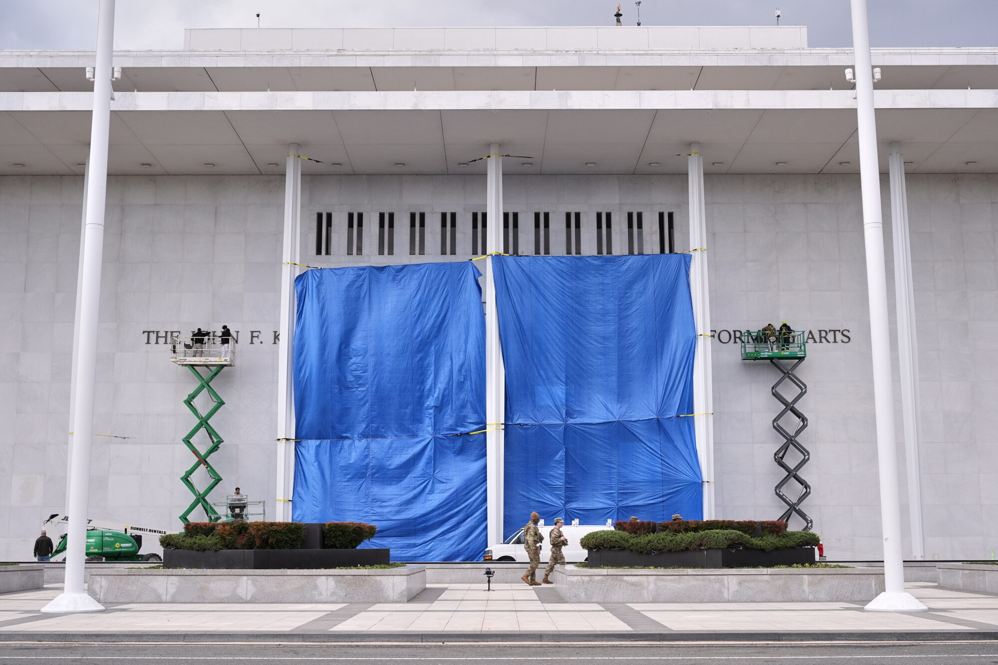 Workers install Donald J. Trump's name above the current signage on the Kennedy Center.