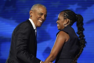 Former President Barack Obama hugs former first lady Michelle Obama