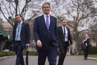 Scott Bessent walks to speak with reporters at the White House.
