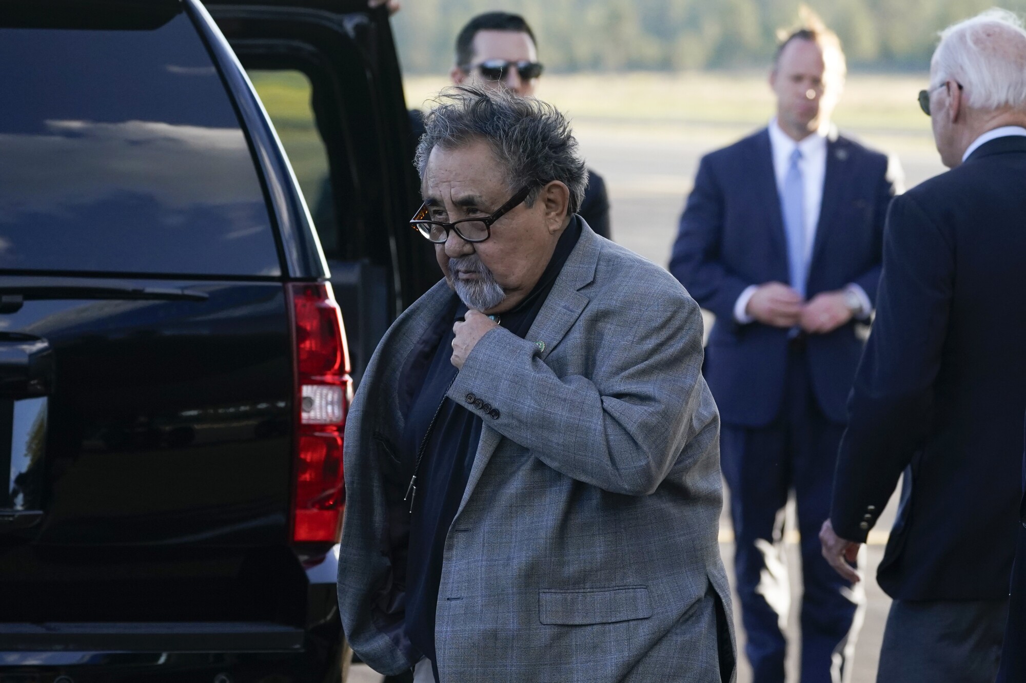 Raul Grijalva walks away from Biden.