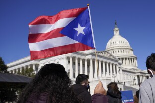 A woman waves the flag of Puerto Rico