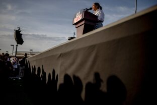 Rep. Alexandria Ocasio-Cortez speaks during a stop of the 'Fighting Oligarchy' rally at Folsom lake College