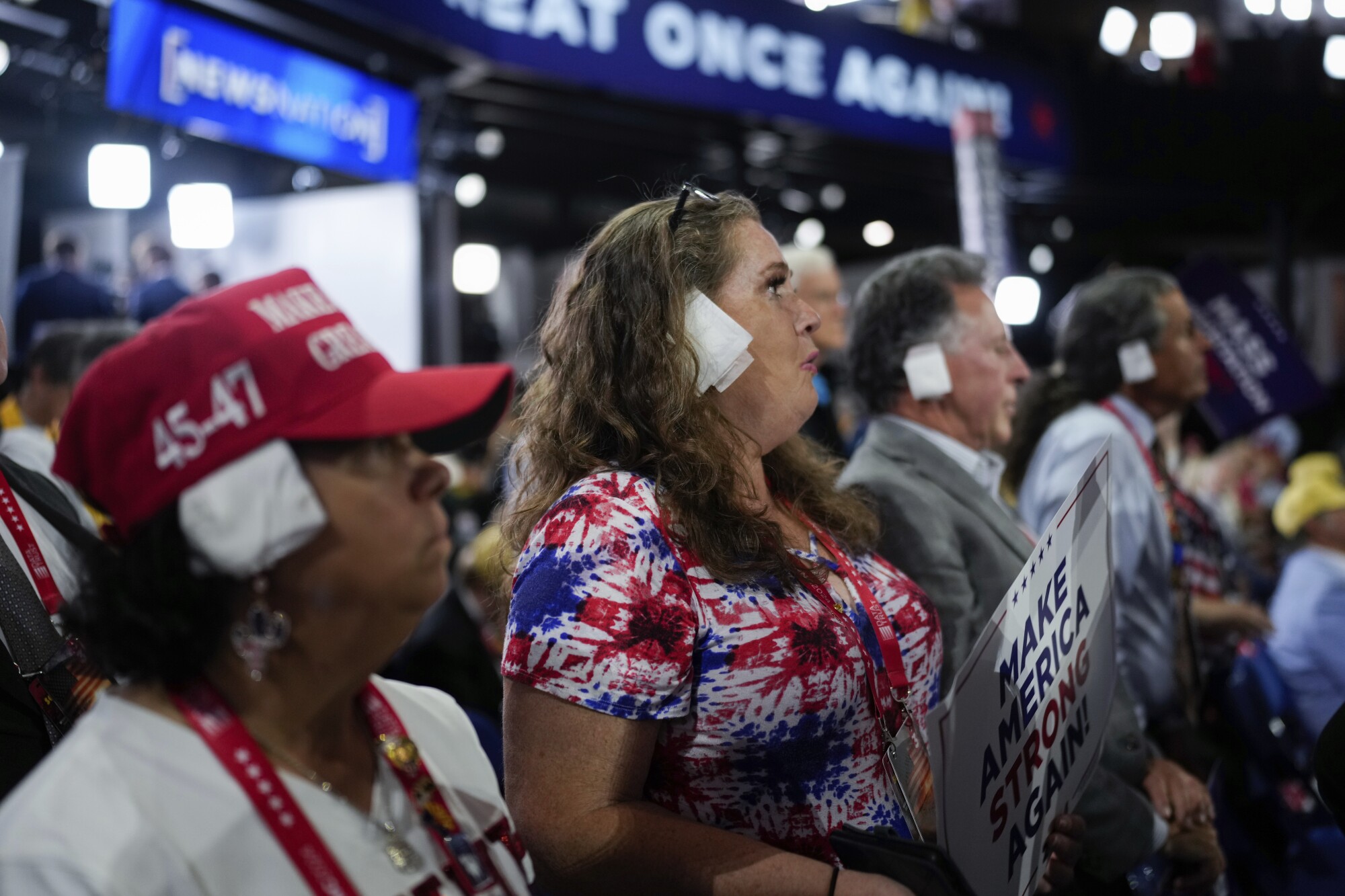 Delegates wear a bandage on their right ear.