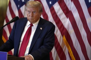 Donald Trump listens to a question as he speaks at Trump Tower.
