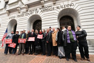 Plaintiffs and supporters pose for pictures outside of the Fifth Circuit Court of Appeals.