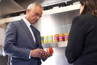 Kennedy Jr. reads the nutrition label on the back of a jar of food.