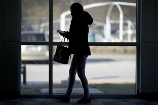 A woman looks at her phone.
