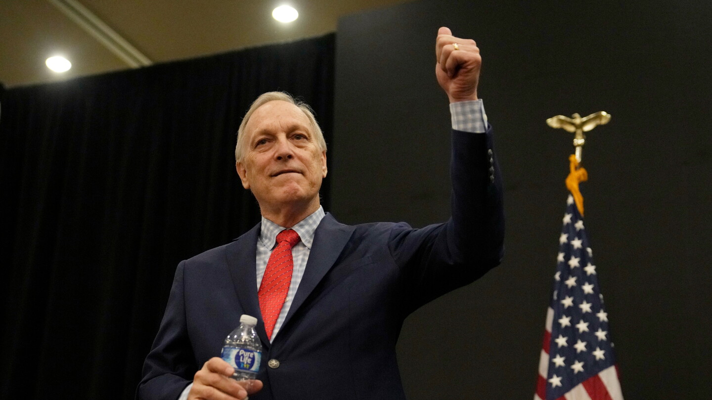 Andy Biggs gives a thumbs up to supporters at a campaign event.