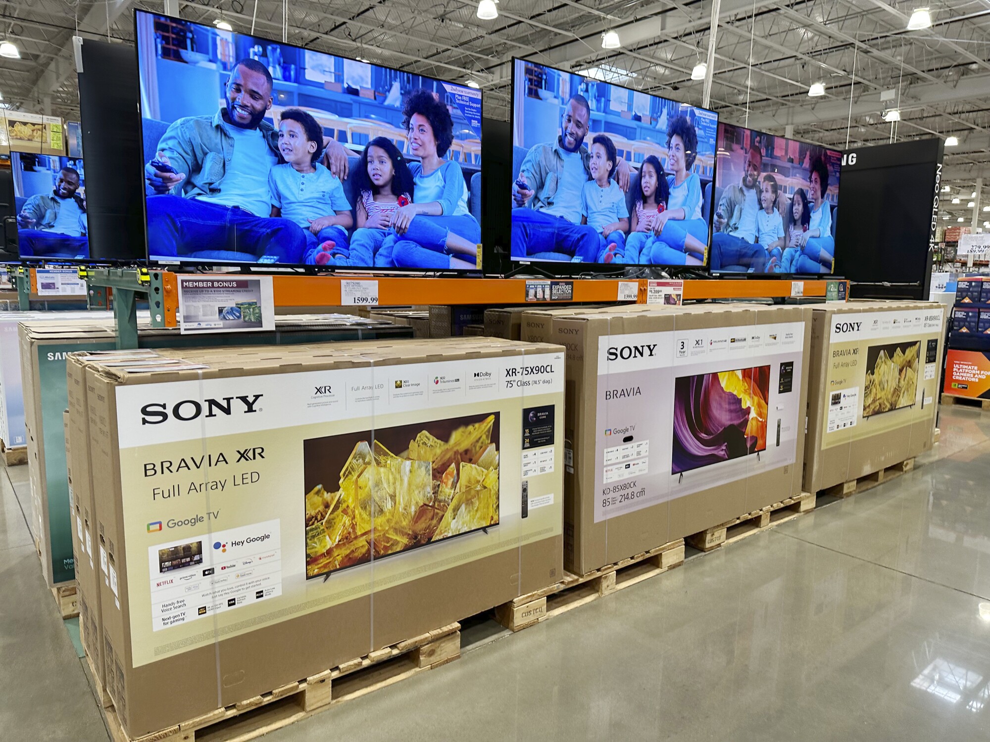 Big-screen televisions sit on display in a Costco warehouse.