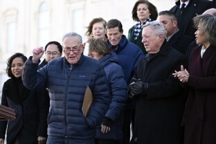 Chuck Schumer with Senate Democrats on the steps of the capitol.