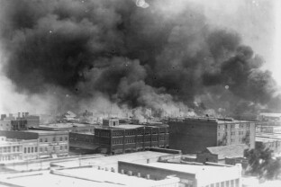 Smoke billows over Tulsa, Okla in this 1921 image from the Library of Congress.