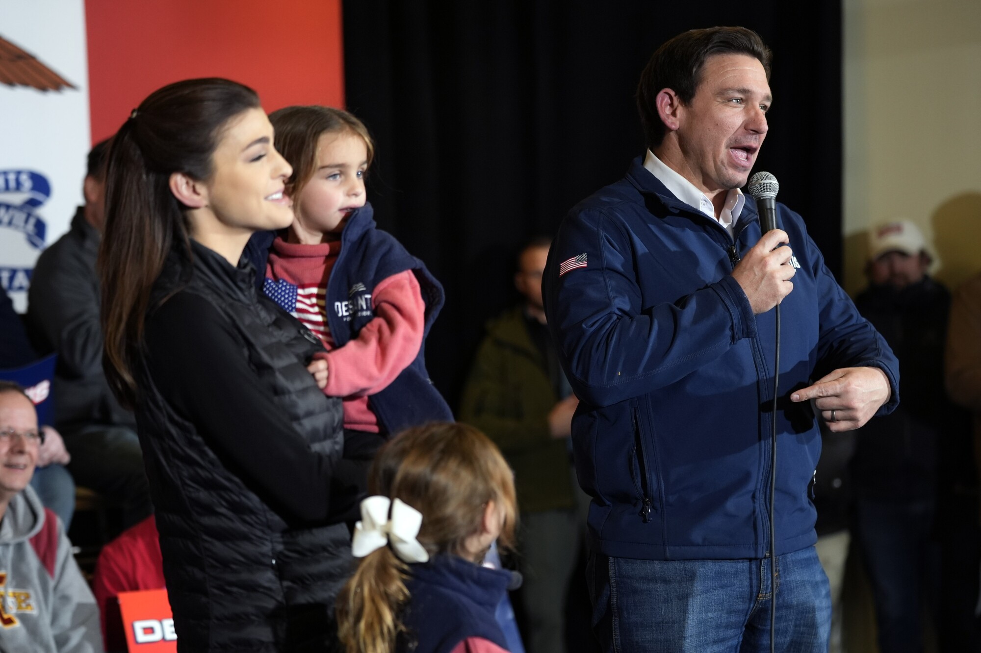 Gov. Ron DeSantis points to his wife Casey and their children. 