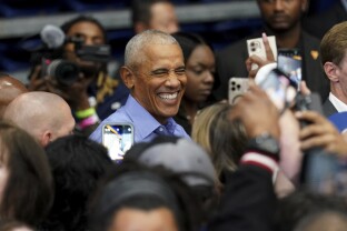 Obama greets attendees after speaking at a campaign rally.