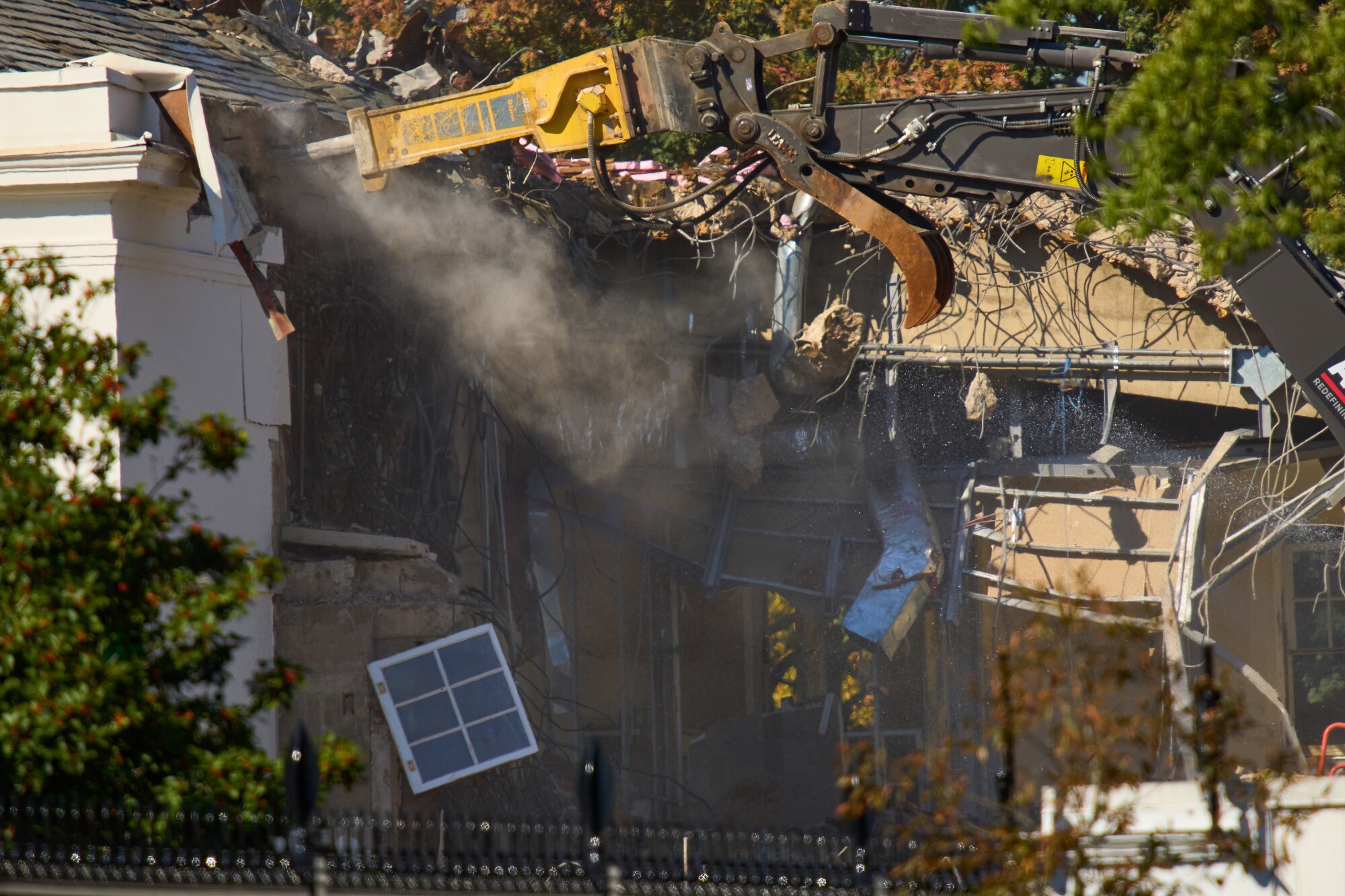 A window dangles as work continues on demolition of the White House’s East Wing