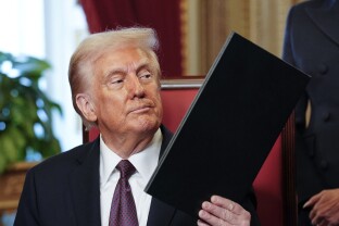 President Donald Trump takes part in a signing ceremony in the President's Room.