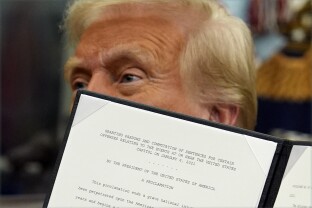 President Donald Trump signs an executive order pardoning about 1,500 defendants charged in the Jan. 6 attack.