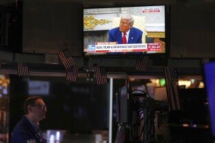 Trump is seen on the television as traders work on the floor at the New York Stock Exchange.