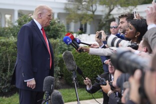 President Donald Trump speaks with reporters before boarding Marine One on the South Lawn of the White House