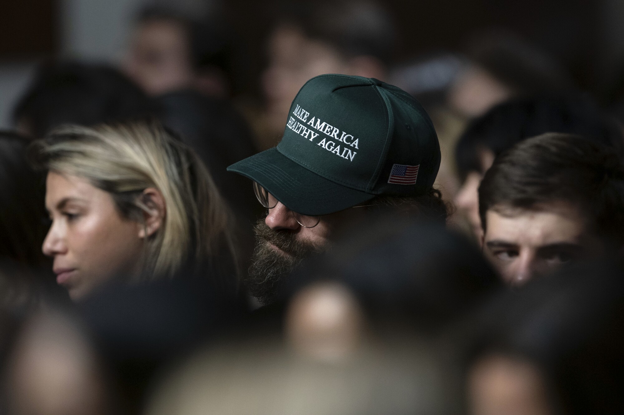 A Robert F. Kennedy Jr. supporter wears a "Make America Healthy Again" hat at Kennedy's confirmation hearing.