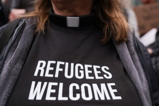 A pastor participates in a protest in support of refugee resettlement.