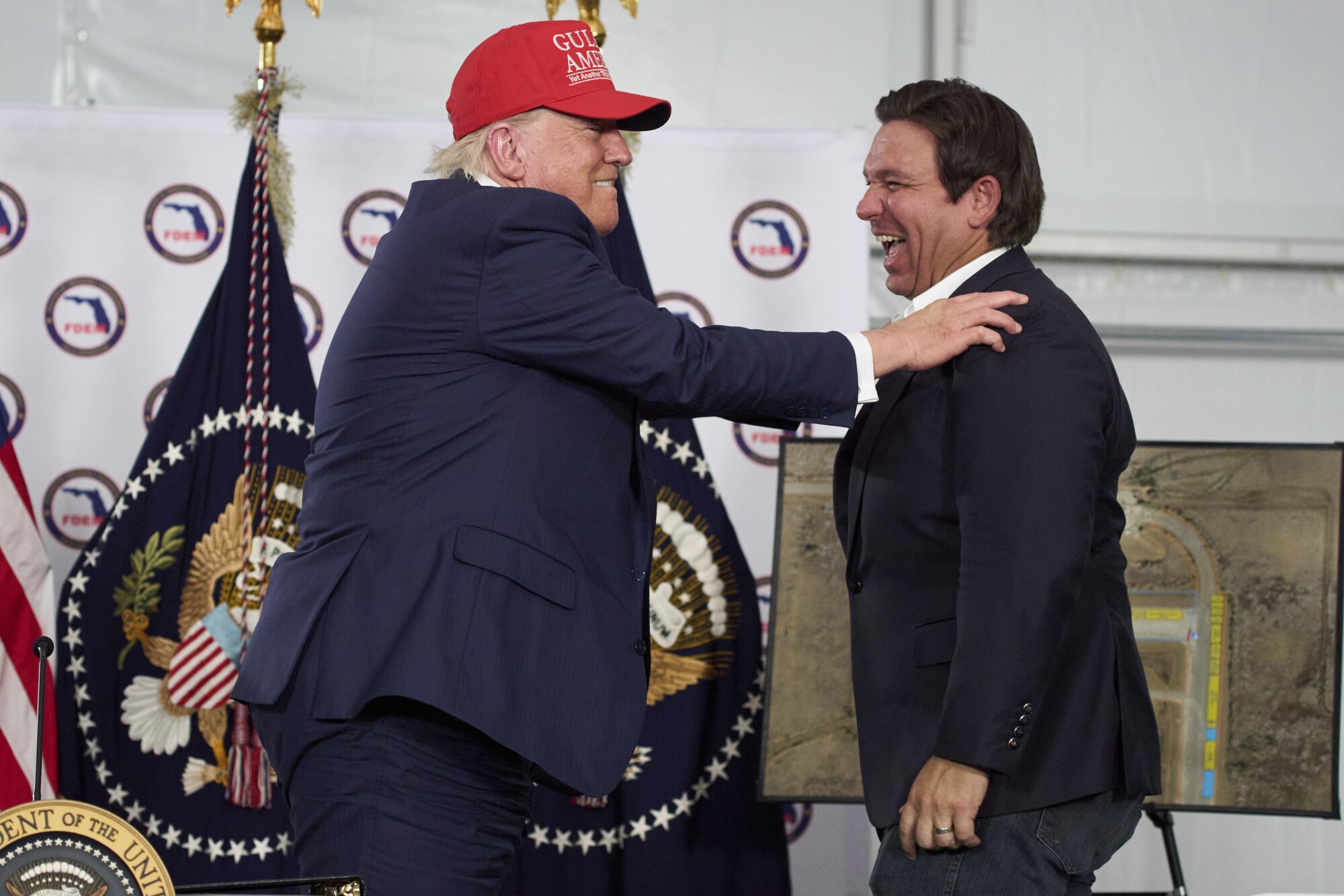 President Donald Trump talks with Gov. Ron DeSantis