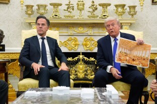 President Donald Trump holds an artist rendering of the interior of the new White House ballroom