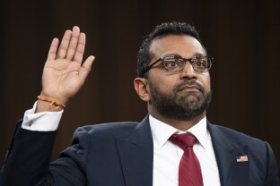 Kash Patel is sworn in before testifying during his confirmation hearing.