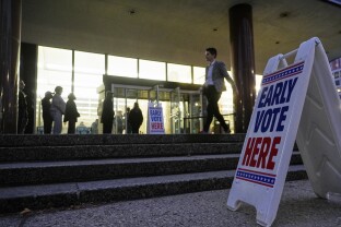People line up during the first day of Wisconsin's in-person absentee voting.