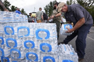 Volunteers stage water for people in the aftermath of Hurricane Helene.